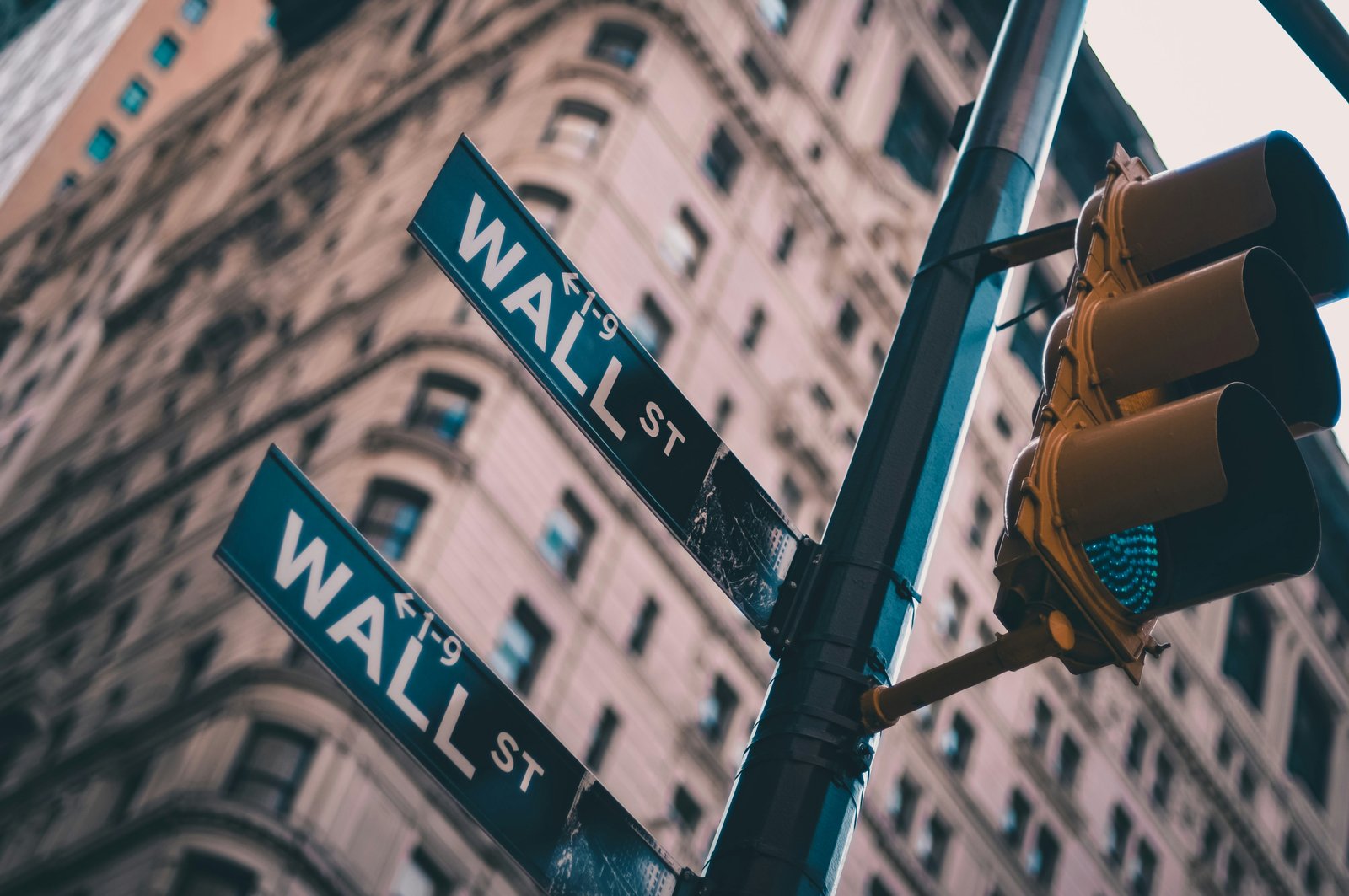 A Wall Street sign beneath a traffic light in New York City